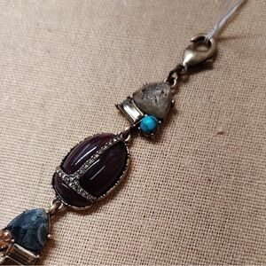 Chloe + Isabel Wild Earth Scarab Gold Bracelet with PurpleTurquoise Accents
B1